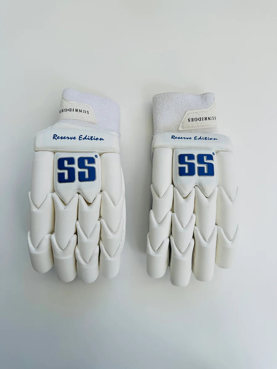 Cricket batting gloves from Cric Studio Canada's SS Reserve Edition, white and black with padded finger and palm protection.