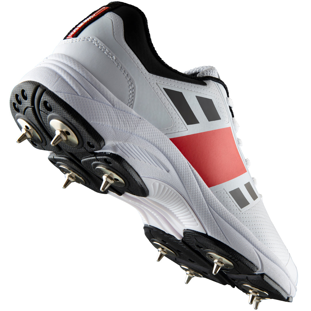 Gray Nicolls Velocity Spike cricket shoes with gray and black design, featuring spike soles for enhanced grip and performance.
