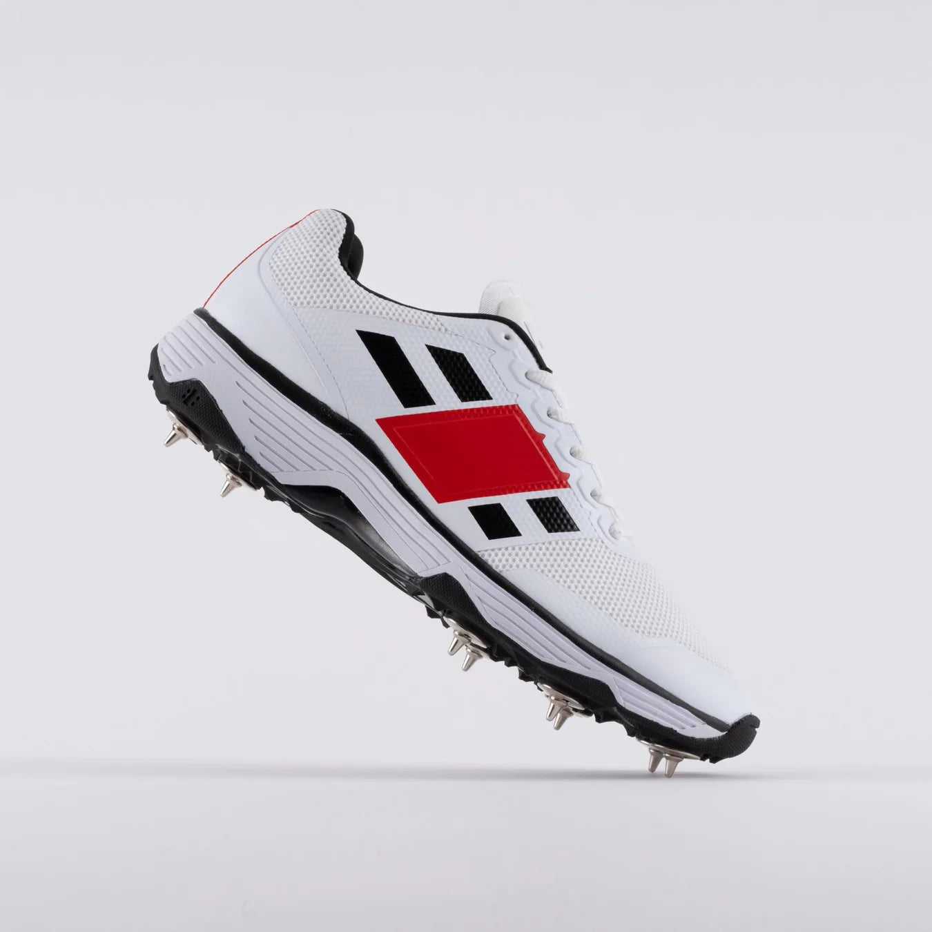 Cricket spike shoes by Cric Studio Canada, GN8 Players Spike Cricket Shoes with side view showing spike tilts and athletic design.