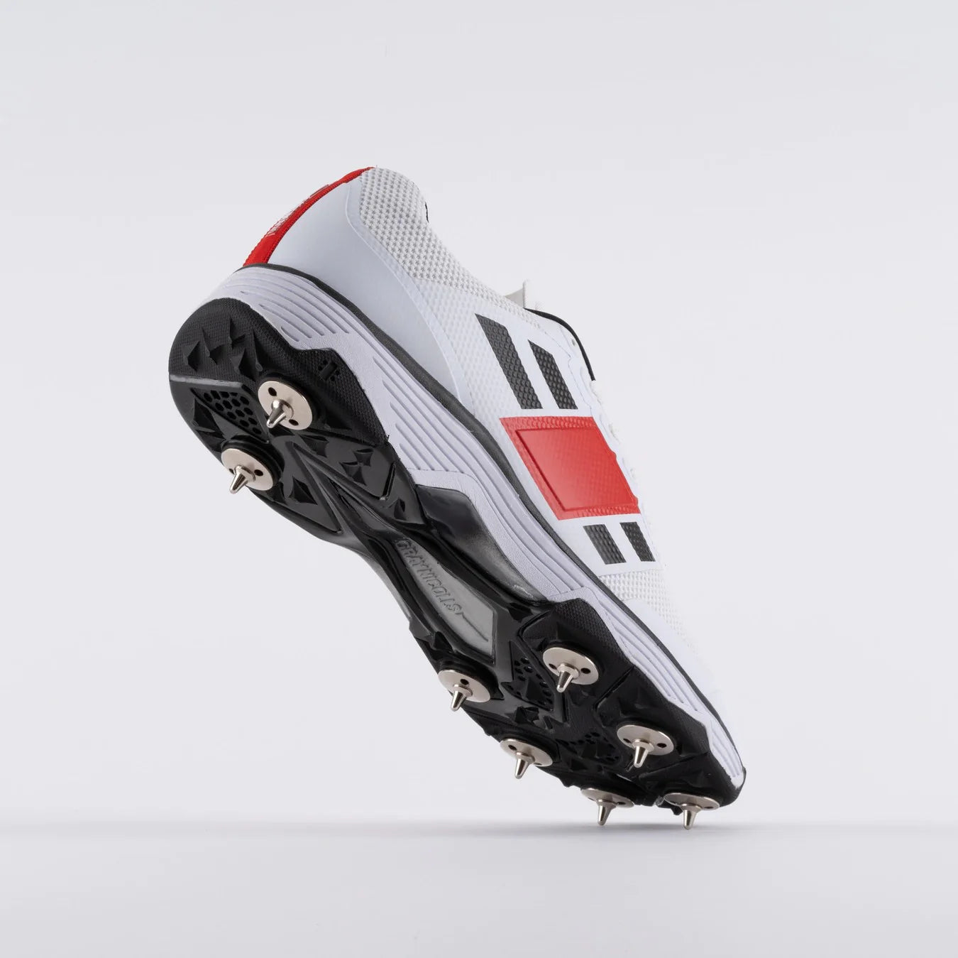 Cricket players spike shoes by Cric Studio Canada with tilt sole for enhanced grip and performance on the cricket field.