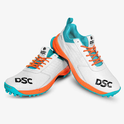 DSC Jaffa 22 cricket shoes in white and orange with supportive design and cleats, suitable for cricket players.